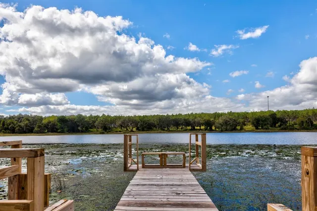 a view of a lake with houses in the back