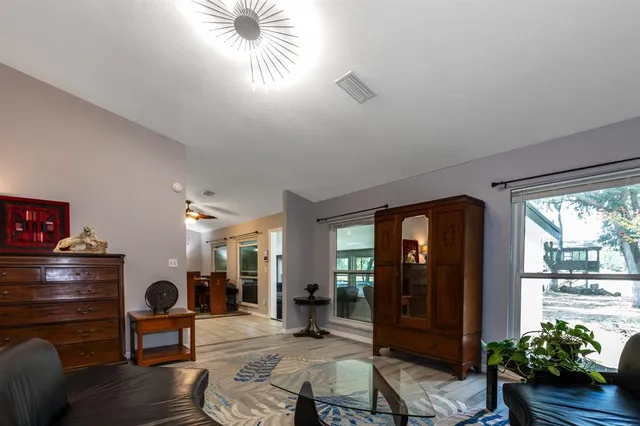 a dining room with furniture and wooden floor