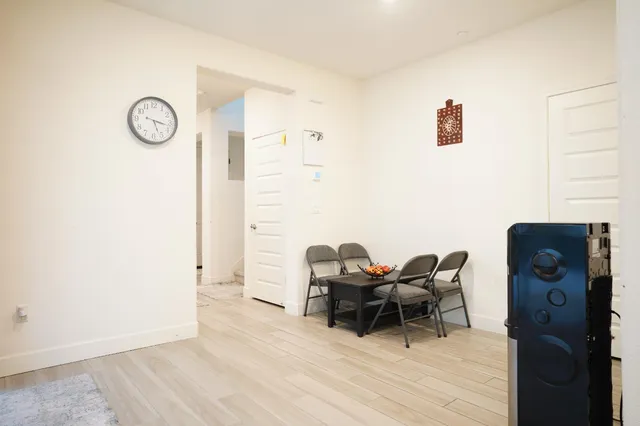 a view of a workspace with furniture and wooden floor