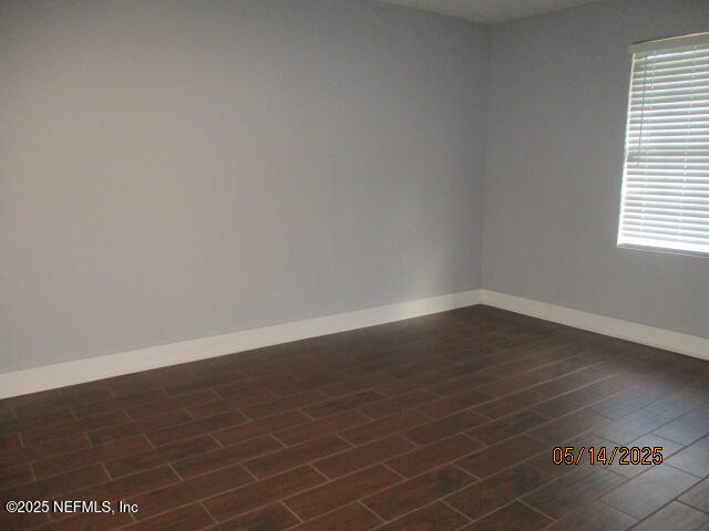 716 Shortputt Drive Macclenny, FL 32063 - Photo 13 of 24 a view of an empty room with wooden floor and a window