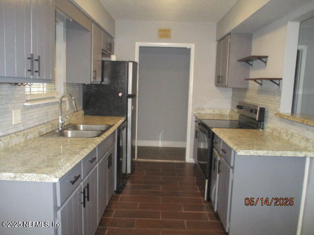 716 Shortputt Drive Macclenny, FL 32063 - Photo 5 of 24 a kitchen with stainless steel appliances granite countertop a sink stove and refrigerator