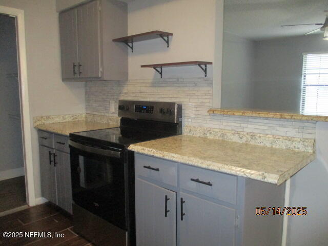 716 Shortputt Drive Macclenny, FL 32063 - Photo 6 of 24 a kitchen with granite countertop a sink stove and cabinets