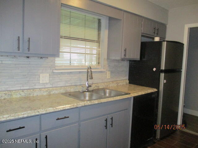 716 Shortputt Drive Macclenny, FL 32063 - Photo 7 of 24 a kitchen with stainless steel appliances granite countertop a refrigerator and a sink
