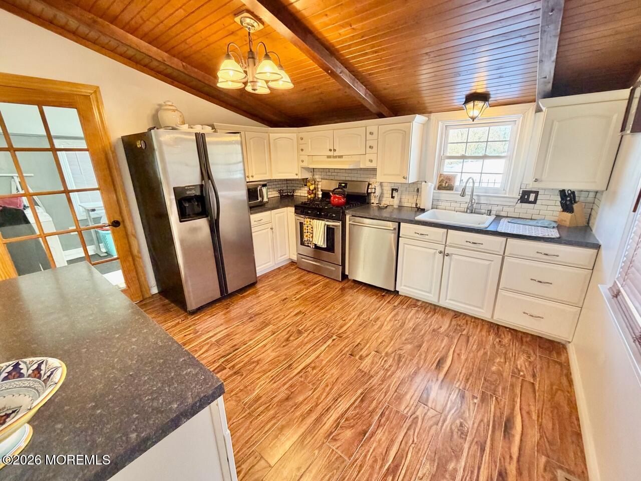 623 Main Street Leesburg, NJ 08327 - Photo 30 of 68 a kitchen with stainless steel appliances granite countertop a refrigerator a sink dishwasher a stove and white countertops with wooden floor