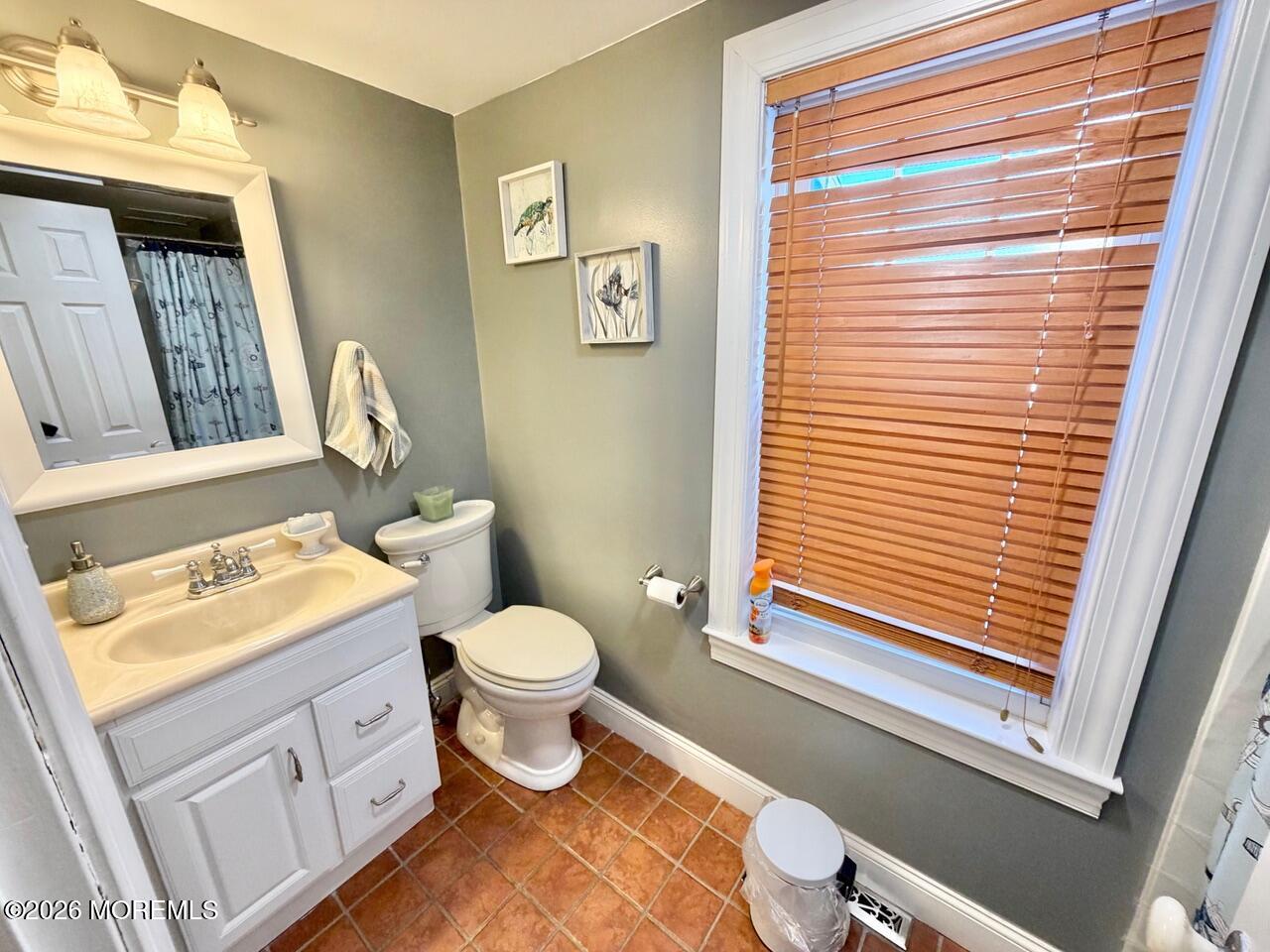 623 Main Street Leesburg, NJ 08327 - Photo 43 of 68 a bathroom with a toilet sink vanity and window