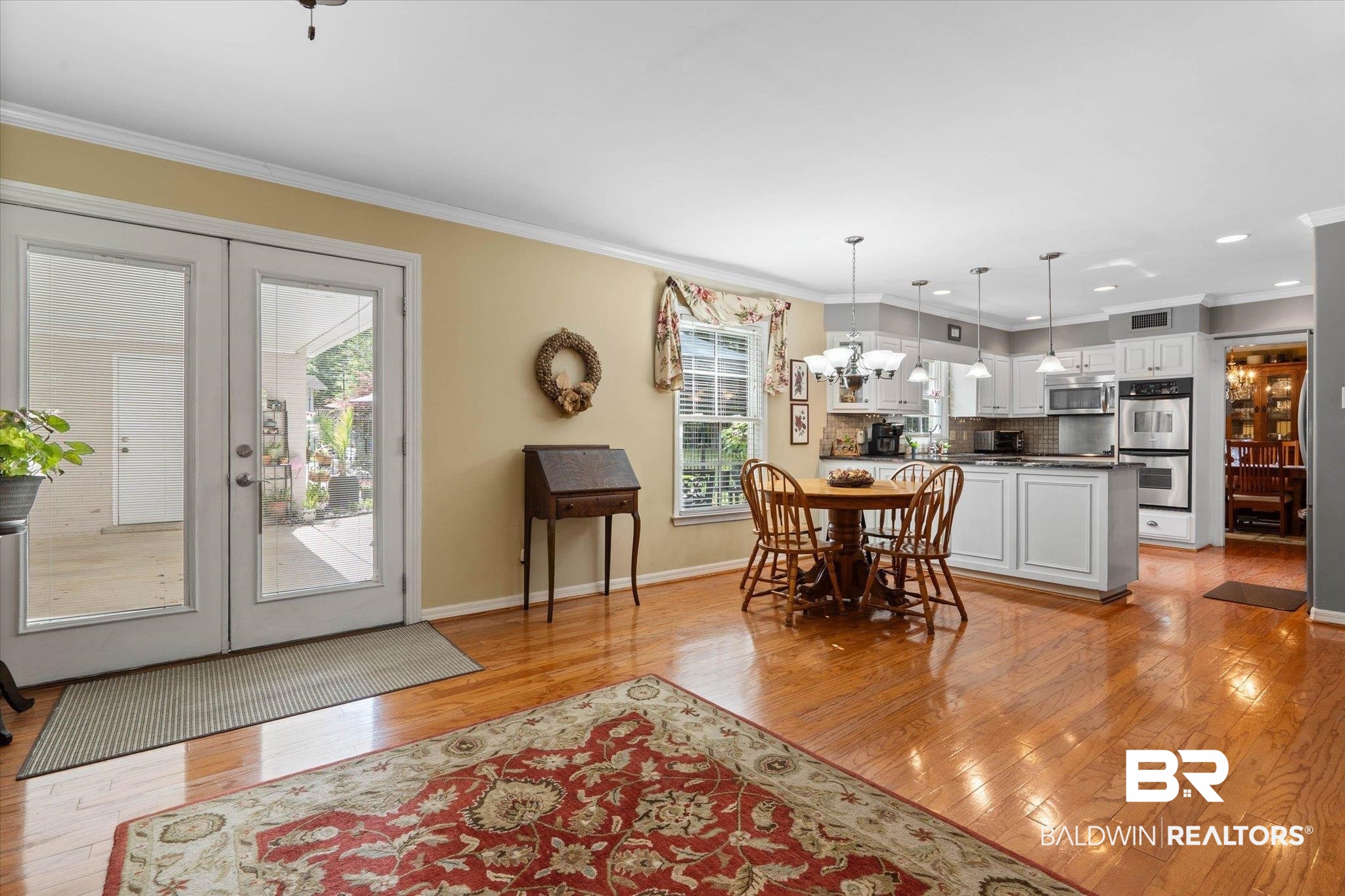 559 East Cumberland Road Mobile, AL 36608 - Photo 15 of 48 Dining area with ornamental molding, light wood finished floors, french doors, and a chandelier