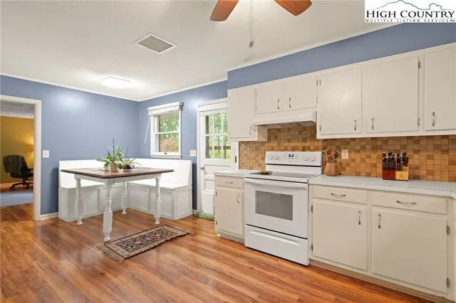 a kitchen with a sink cabinets and window
