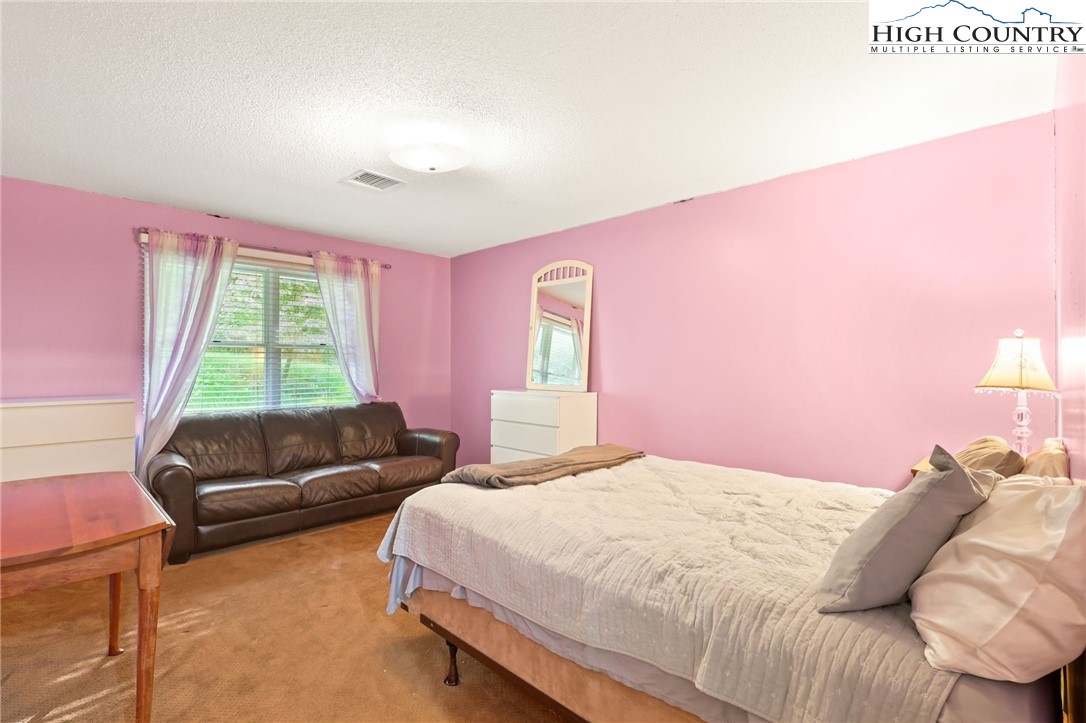 357 Kalmia Lane Boone, NC 28607 - Photo 15 of 41 a bedroom with a bed and a couch
