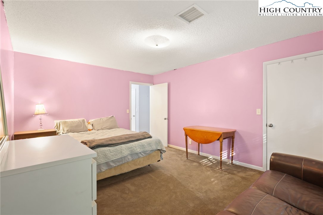357 Kalmia Lane Boone, NC 28607 - Photo 16 of 41 a bedroom with a bed and a couch