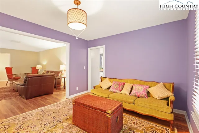 a bedroom with furniture and wooden floor