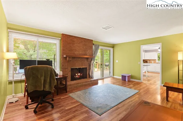 a living room with furniture rug and a fireplace