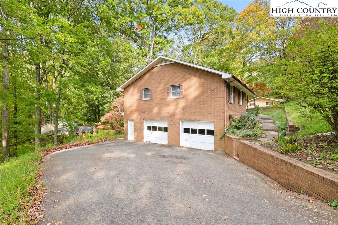 357 Kalmia Lane Boone, NC 28607 - Photo 2 of 41 a view of a house with a yard and large tree