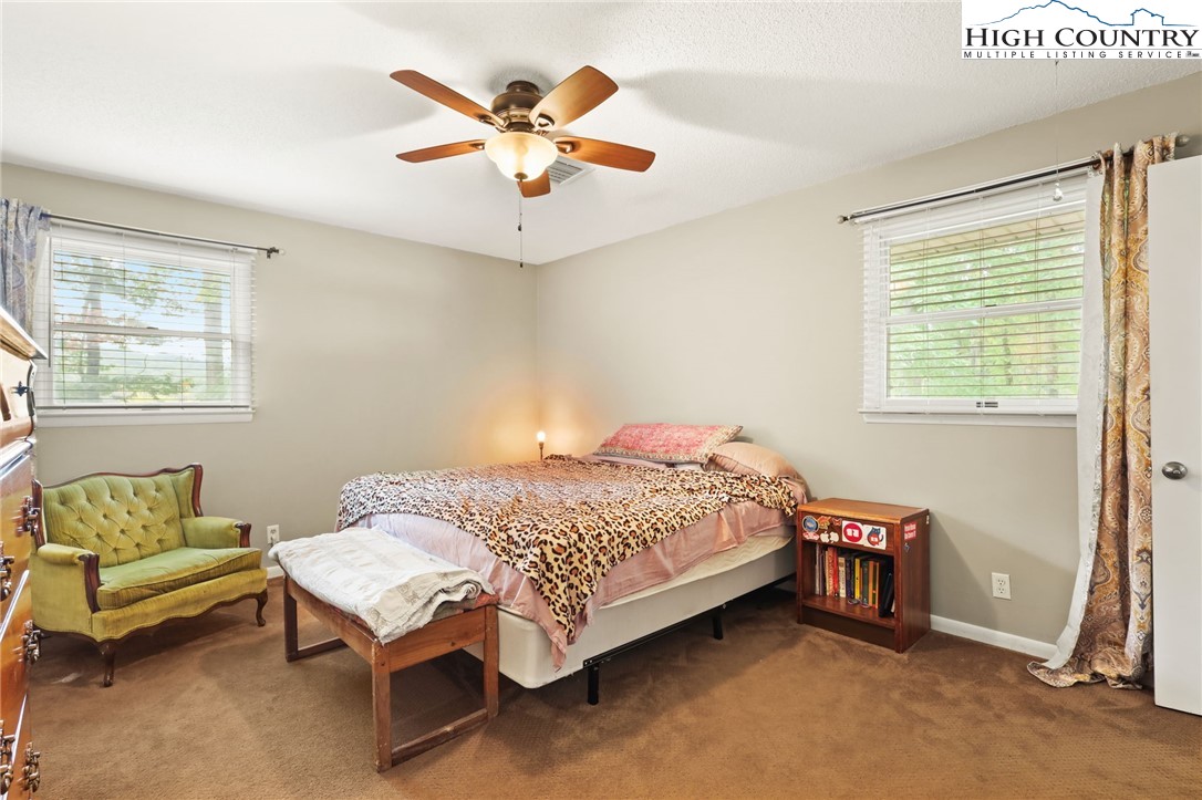 357 Kalmia Lane Boone, NC 28607 - Photo 22 of 41 a bedroom with a bed a couch and a window