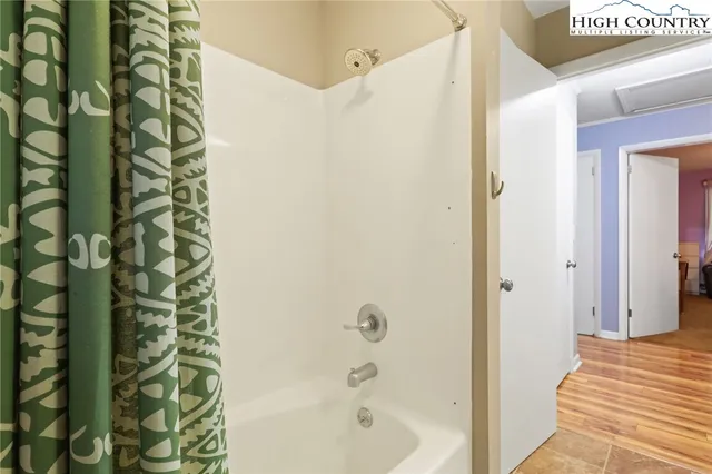 a bathroom with a bathtub and shower