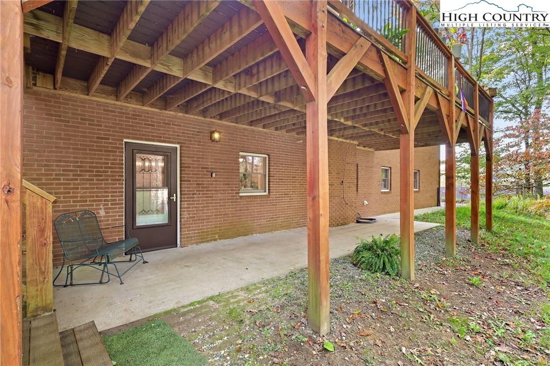 357 Kalmia Lane Boone, NC 28607 - Photo 29 of 41 a porch with a table and chairs next to a yard