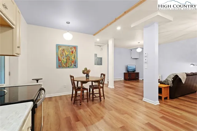 a view of a dining room with furniture and wooden floor