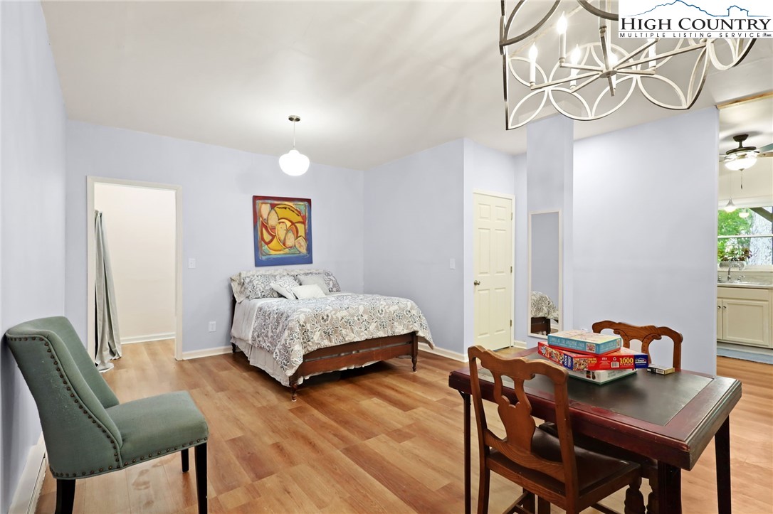 357 Kalmia Lane Boone, NC 28607 - Photo 34 of 41 a bedroom with a bed and a chandelier