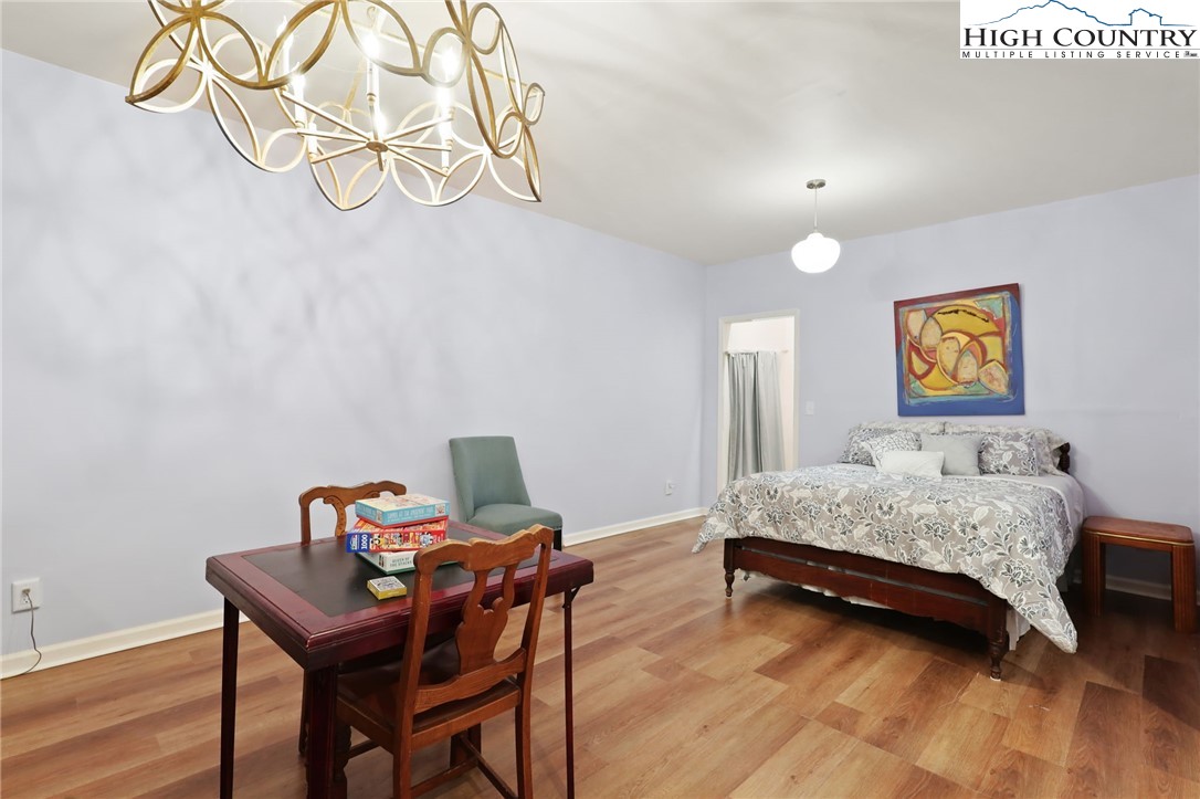 357 Kalmia Lane Boone, NC 28607 - Photo 36 of 41 a bedroom with a bed and a table in it