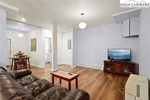 a living room with furniture and a flat screen tv