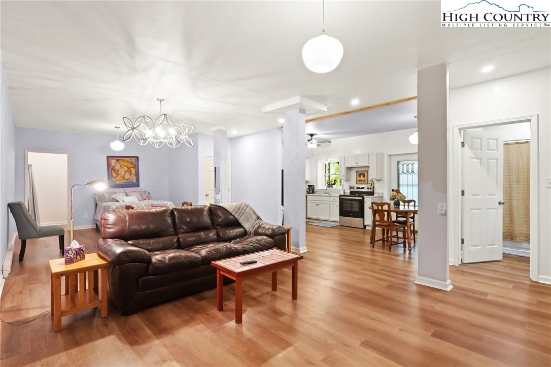 357 Kalmia Lane Boone, NC 28607 - Photo 39 of 41 a living room with furniture kitchen view and a chandelier