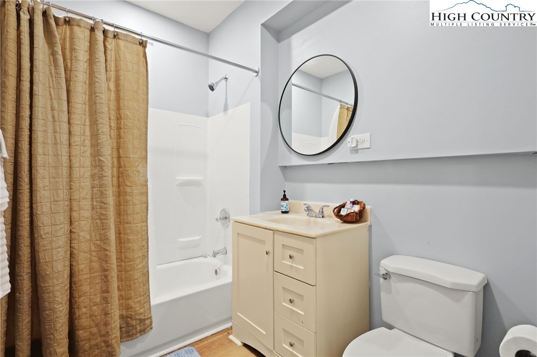 357 Kalmia Lane Boone, NC 28607 - Photo 40 of 41 a bathroom with a sink a toilet and a mirror