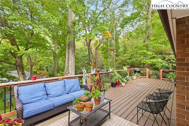 a view of a chairs and table on the wooden deck