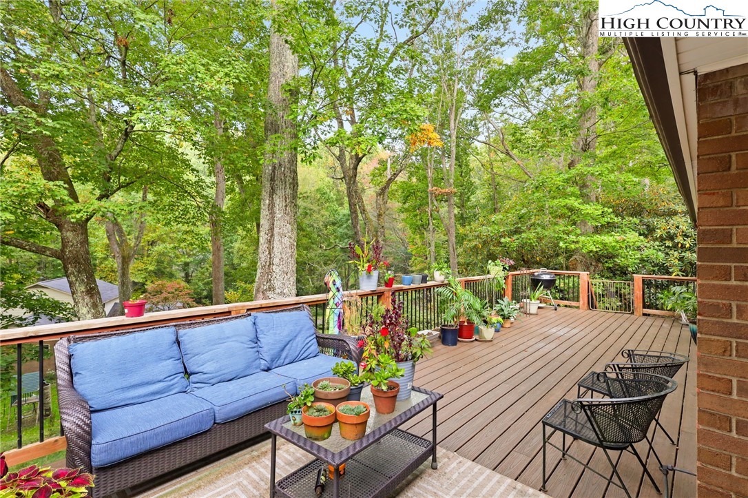 357 Kalmia Lane Boone, NC 28607 - Photo 4 of 41 a view of a chairs and table on the wooden deck