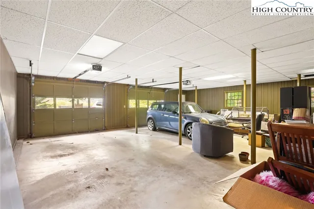 a living room with furniture a rug and a large window