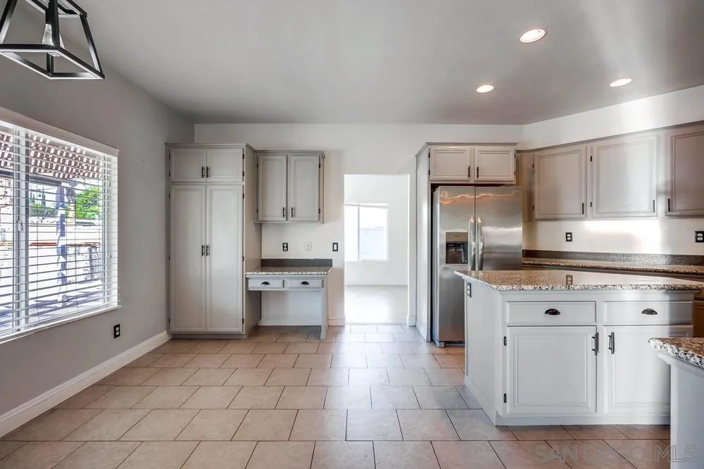 32789 Starlight Street Wildomar, CA 92595 - Photo 14 of 41 a kitchen with a refrigerator a oven and white cabinets