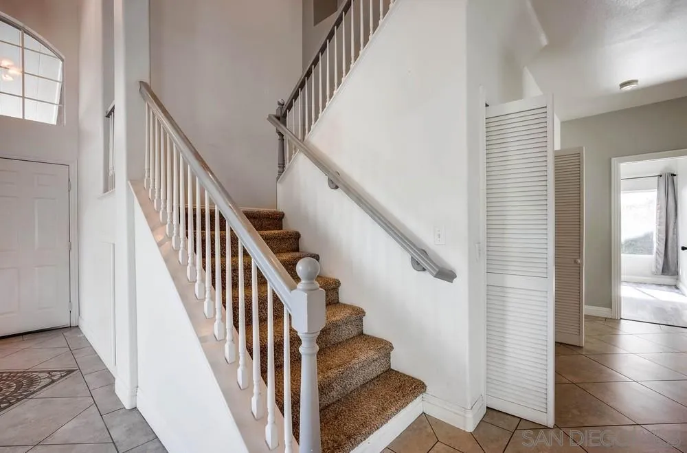 32789 Starlight Street Wildomar, CA 92595 - Photo 18 of 41 a view of staircase with lots of frames on wall and windows