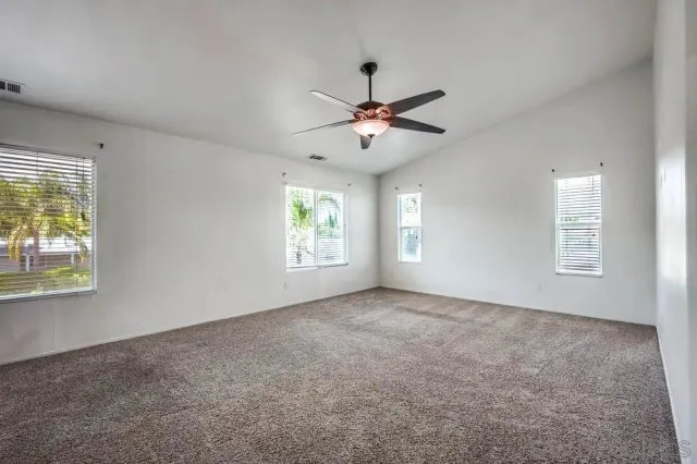 a view of room with a ceiling fan and window