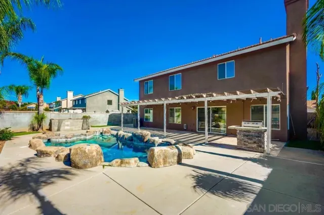 a front view of house with yard outdoor seating and barbeque oven