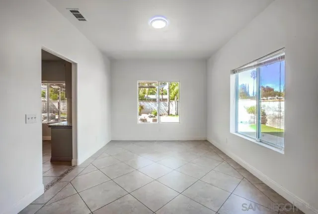 an empty room with windows and closet