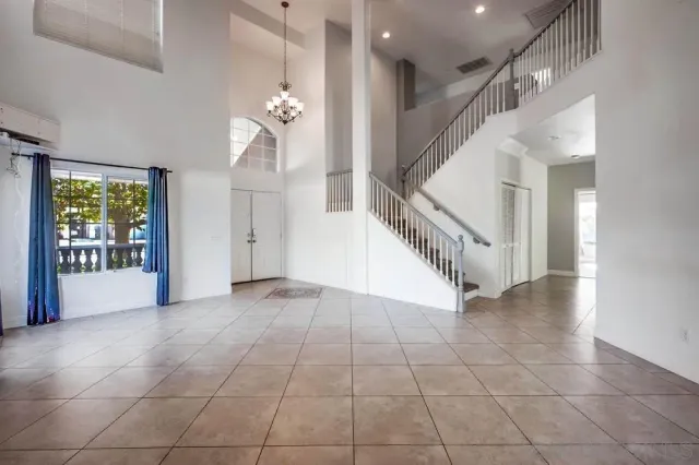 a view of entryway and hall with a living room