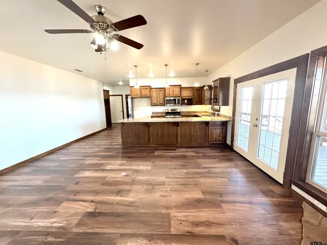 a kitchen with stainless steel appliances granite countertop a stove a sink and a refrigerator