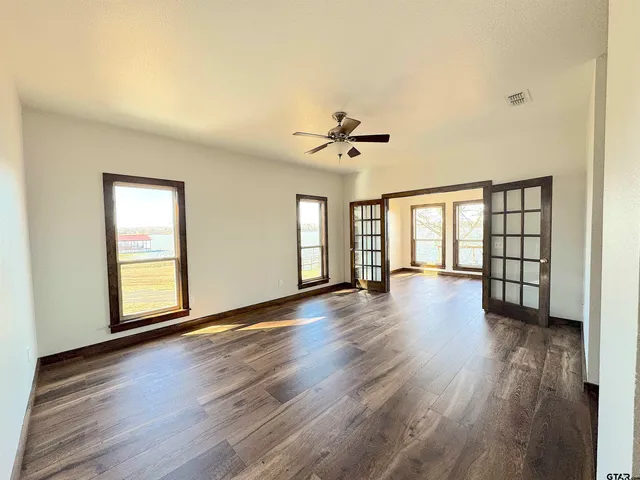 wooden floor in an empty room with a window