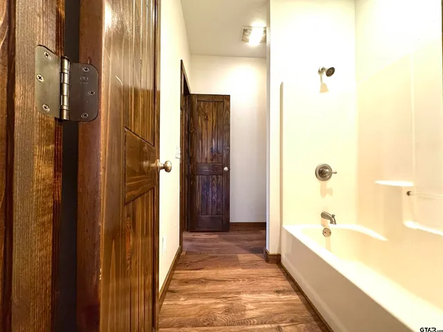 a bathroom with a toilet and a tub