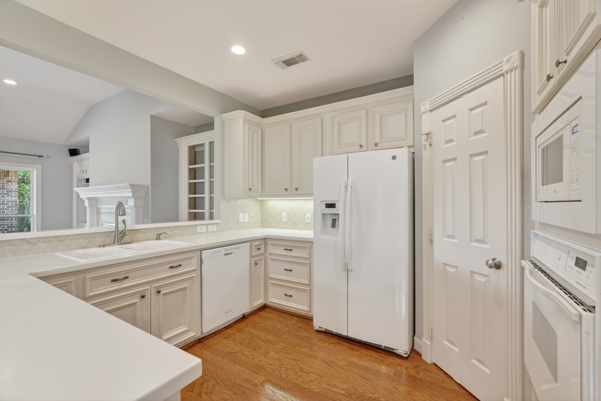 20714 Flora View Court Spring, TX 77379 - Photo 20 of 40 a kitchen with white cabinets and white appliances