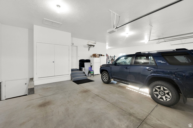 352 East Boulderville Road Oakley, UT 84055 - Photo 36 of 62 Garage featuring freestanding refrigerator
