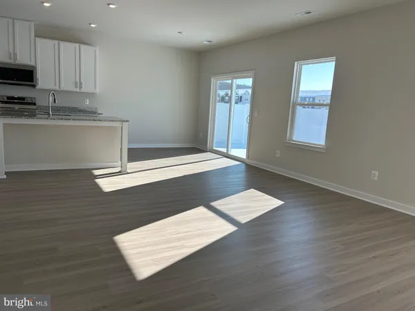 a view of kitchen with granite countertop cabinets and wooden floor