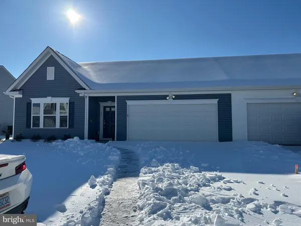 a view of a bedroom with a bed and wooden floor