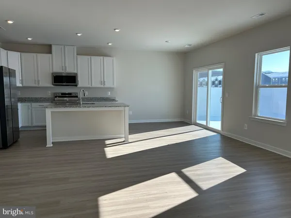 a kitchen with stainless steel appliances granite countertop a stove and a refrigerator
