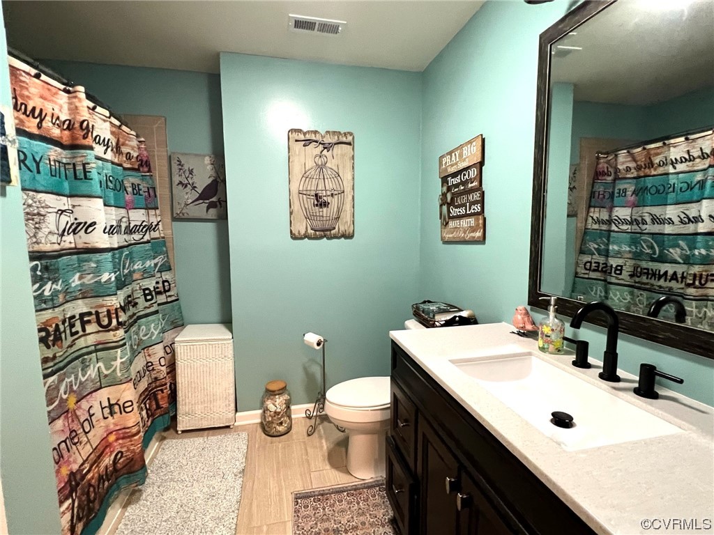 4520 Cralles Road Amelia Court House, VA 23002 - Photo 13 of 21 a bathroom with a sink a toilet and mirror