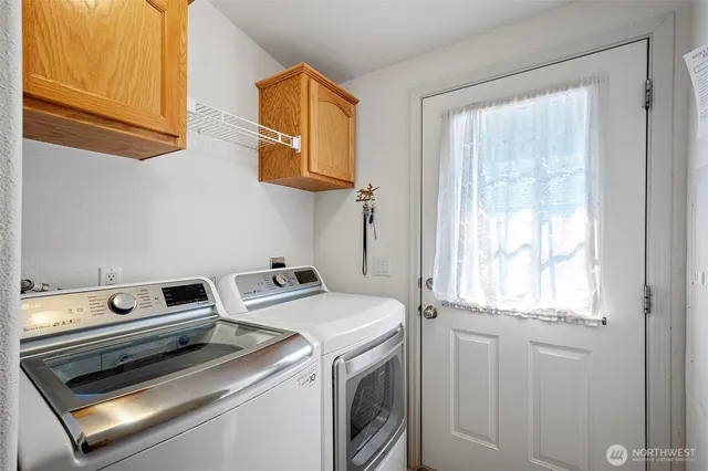 an aerial view of a house with a yard and large trees