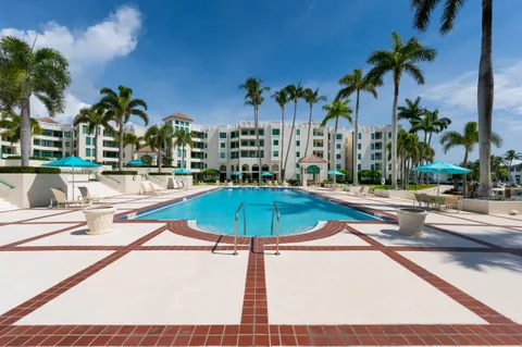 a view of swimming pool is middle in the garden