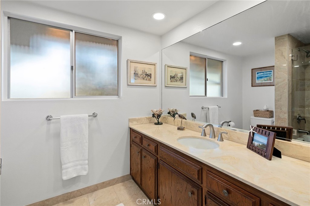3495 Ridgecrest Drive Carlsbad, CA 92008 - Photo 35 of 42 a bathroom with a double vanity sink and a mirror