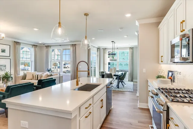 a large white kitchen with a large island