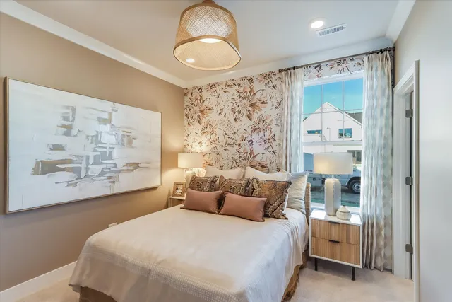 a bedroom with a large bed and a chandelier