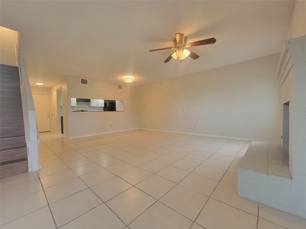 7825 Beauregard Circle, Unit 2A Austin, TX 78745 - Photo 12 of 27 a view of a livingroom with a ceiling fan and window