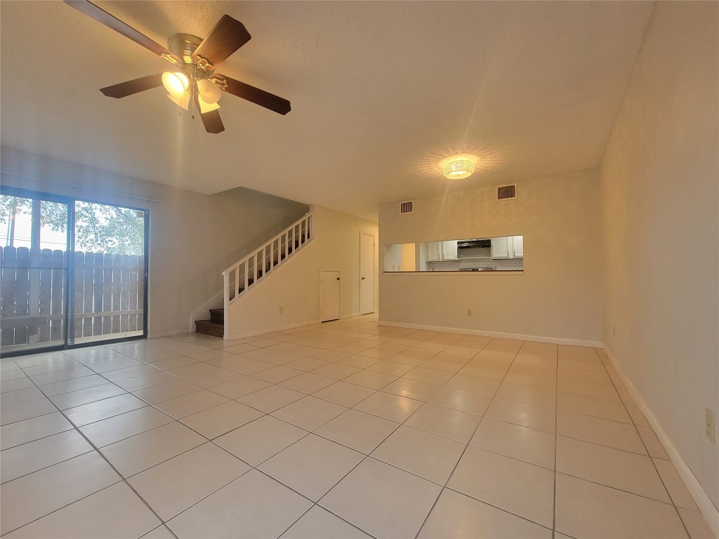 7825 Beauregard Circle, Unit 2A Austin, TX 78745 - Photo 13 of 27 a view of a livingroom with a ceiling fan and window